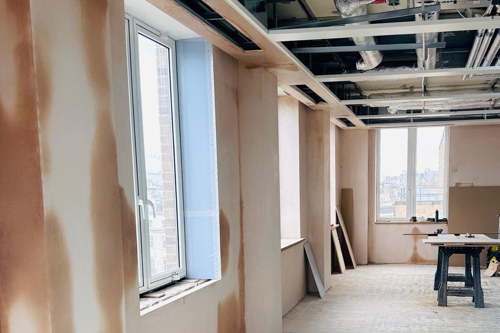 Commercial fit-out — drylining and plaster finish to partitions and reveals. Photographed during finishing.