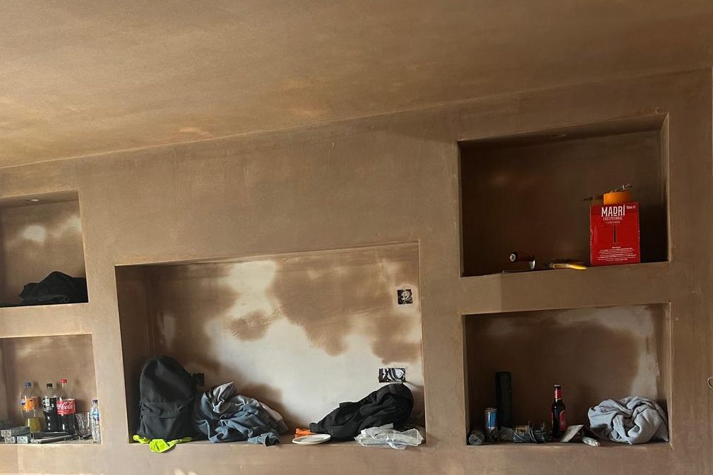 Built-in media wall — plasterboard recesses brought to a smooth plaster finish. Photographed during finishing.